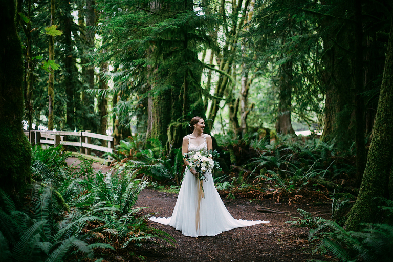 Bride standing in the woods