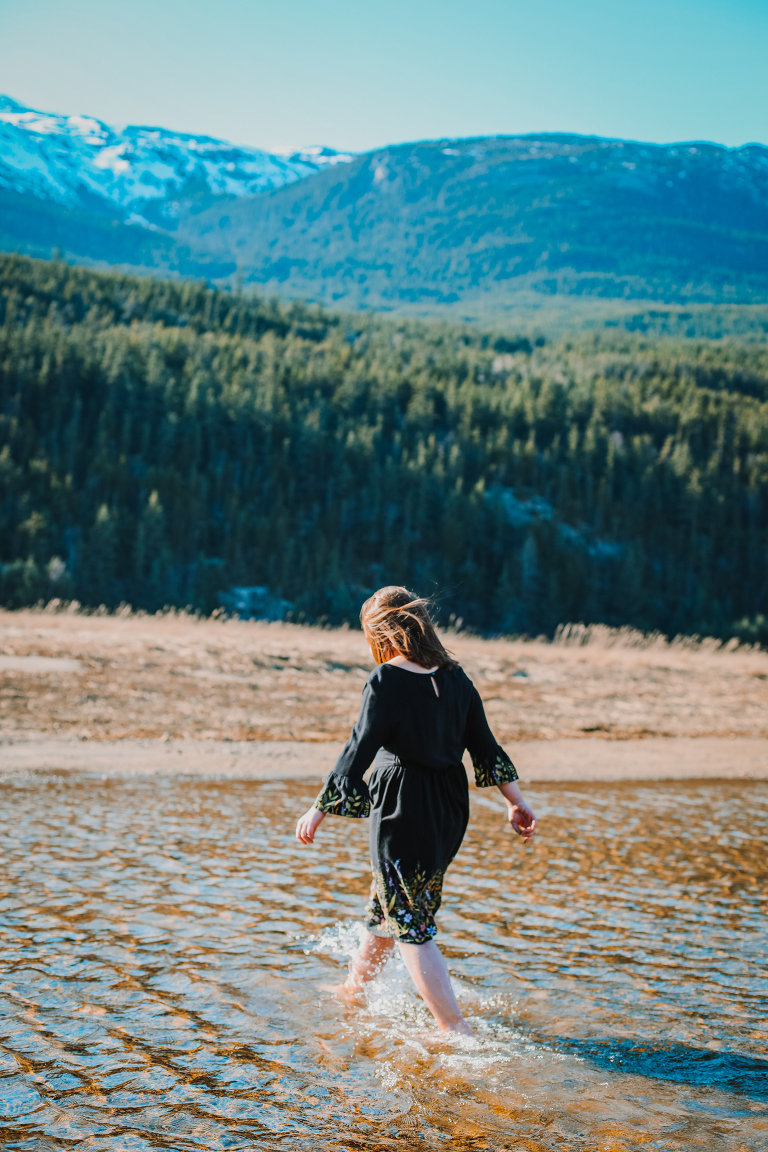 Daughter walks through the cold water. 