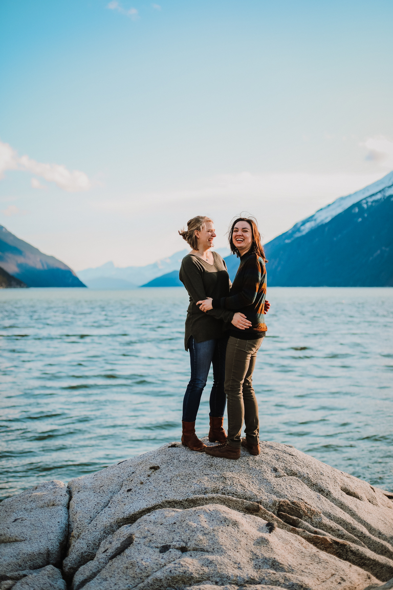 A beautiful lesbian couple laughing with each other at Yakutania Point.