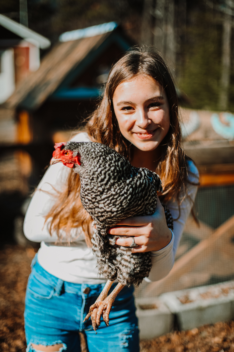 Daughter holds up her favorite chicken and smiles. 