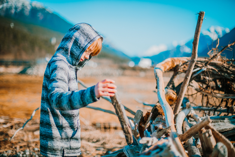 A young boy builds a beach fort in Skagway. 