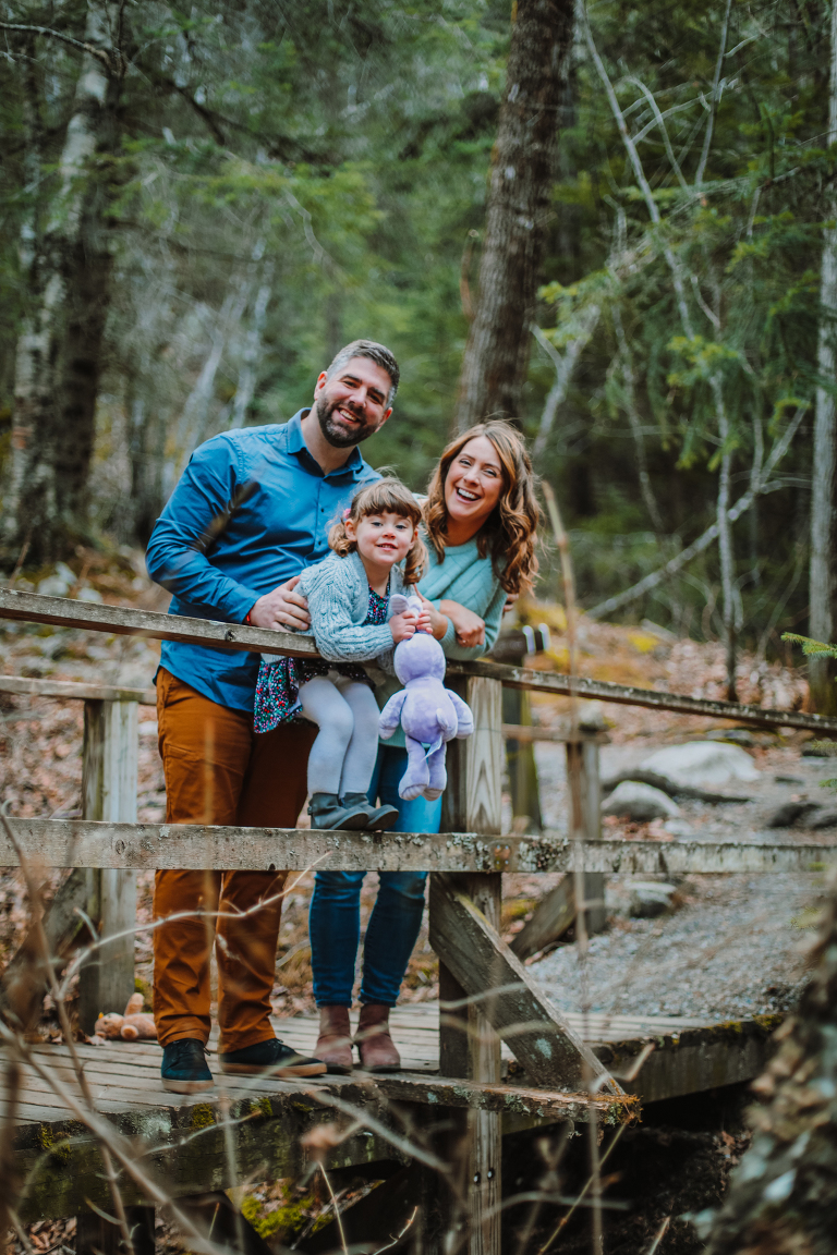 The Wagner Family laughs and smiles for a family photo on a wood bridge to Lower Reid Falls. 