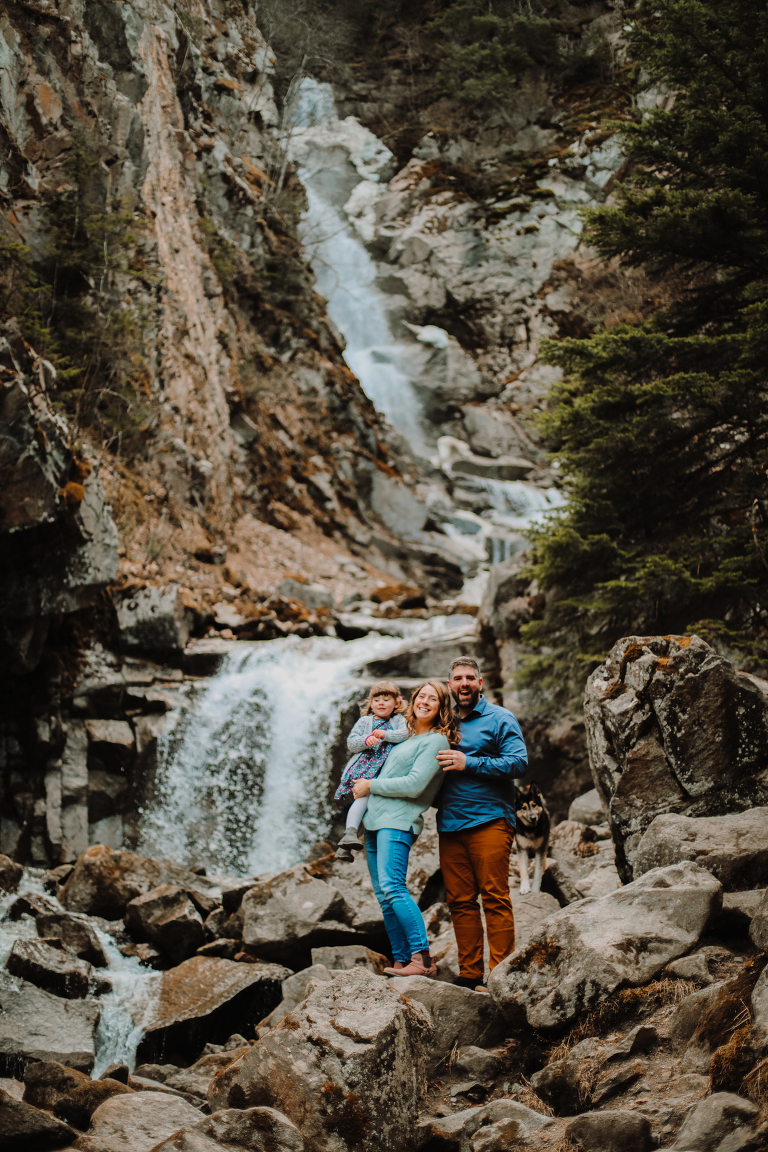 The Wagner Family laughs and smiles for a family photo in front of Lower Reid Falls. 