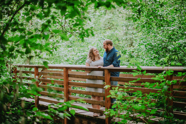 Mallory and Mike look at one another while standing on a bridge in Judd Creek.