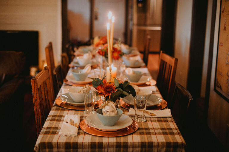The Thanksgiving table is set and the candles are lit. 