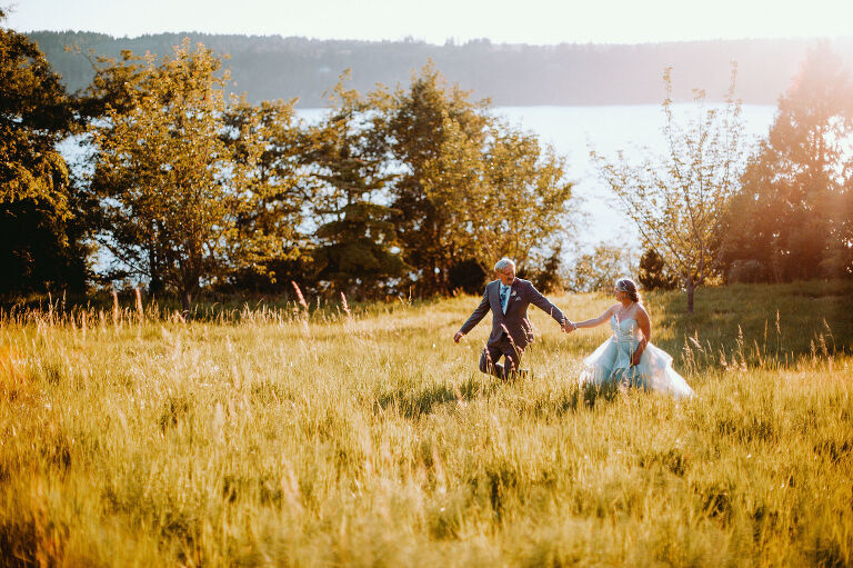 Jay and Kirsten dance together in a field while taking wedding photos. 