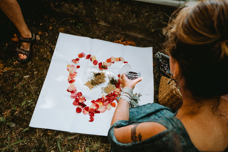 Guests shape their rose petals into a heart  for the bride and groom. 