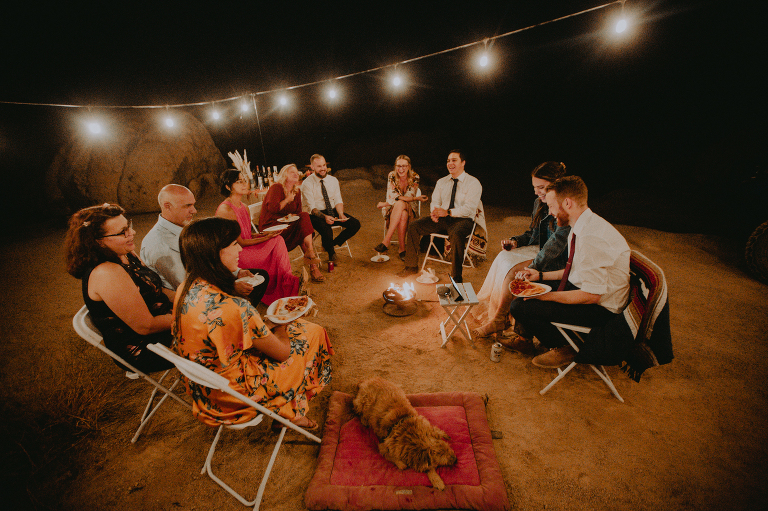 The wedding part sits around a fire exchanging stories in Alabama Hills.