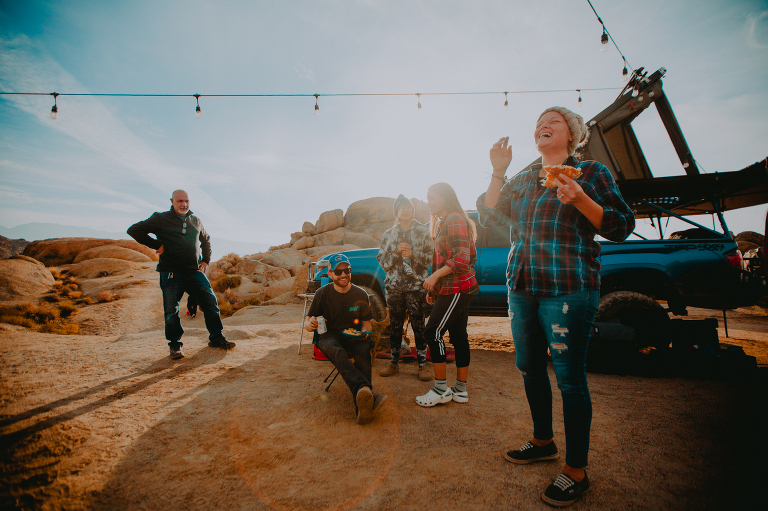 Family and friends laugh over a shared breakfast in Alabama Hills. 