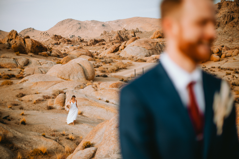 Paul waits on top of a rock formation for his first look with Kristi before their Alabama Hills elopement.