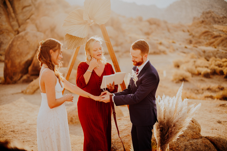Paul puts a ring on Kristi's finger during their Alabama Hills elopement.