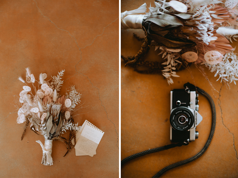 A bouquet and Kristi's film camera are set up for display with rings and special notes inside an Alabama Hills Airbnb.